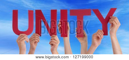 Many Caucasian People And Hands Holding Red Straight Letters Or Characters Building The English Word Unity On Blue Sky
