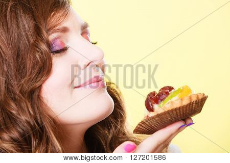 Woman Closed Eyes Holds Cake In Hand