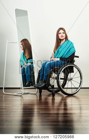 Real people disability and handicap concept. Teen girl handicapped woman sitting on wheelchair in front of mirror combing hair. Daily personal care
** Note: Soft Focus at 100%, best at smaller sizes