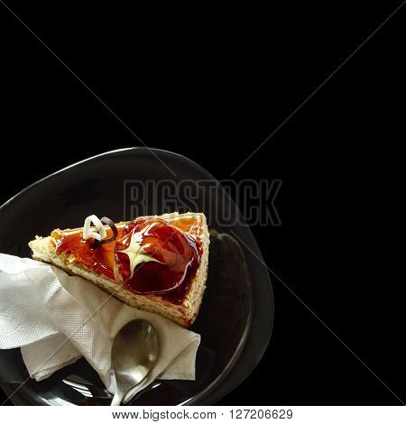 Delicious piece of cake on black plate isolated black background with clipping path