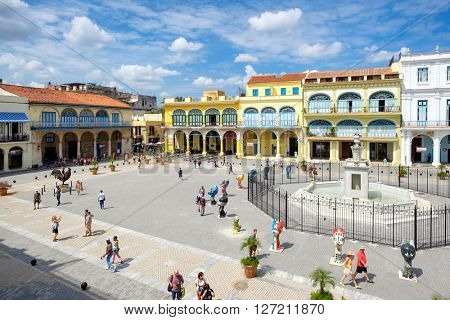 HAVANA,CUBA- APRIL 20,2016 : Tourists and cubans at colorful colonial Old Square in the heart of Old Havana