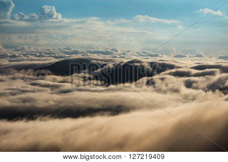 Landscape of mountains covered with clouds at sunrise