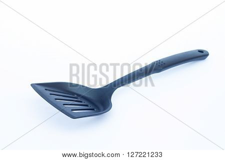 Black plastic kitchen spatula on white background? stock photo