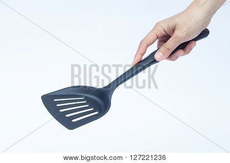 Black plastic kitchen spatula on white background stock photo
