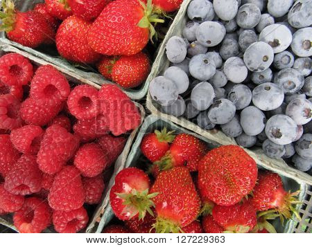Mixed berries, blueberries, strawberries and raspberries in containers