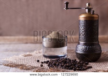 Black pepper corns and Black pepper Powder on wooden background