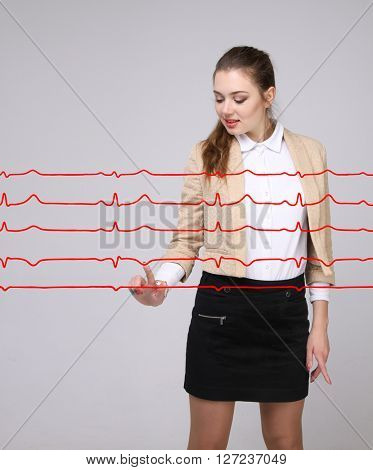 Doctor woman working with cardiogram lines