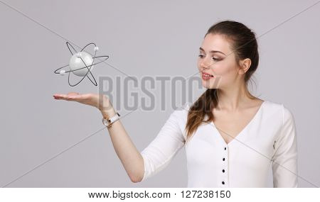 Woman scientist with atom model, research concept