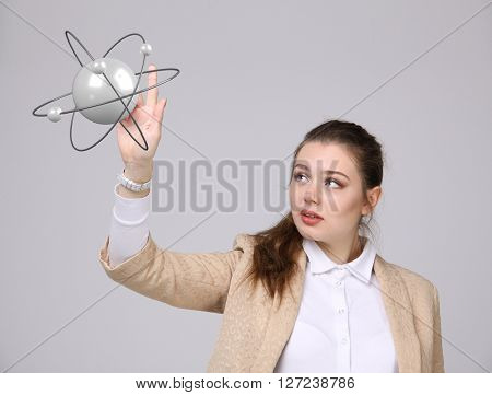 Woman scientist with atom model, research concept