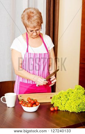Woman cut red onion on cutting board