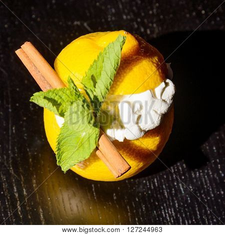 creamy dessert served in lemon halves decorated with smint leaves