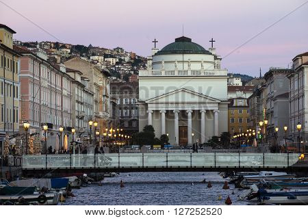 TRIESTE ITALY - OCTOBER 21: scenic evening city scene with view to New Sant'Antonio Church at the end of the Grand Canal in Trieste Italy on October 21 2015.