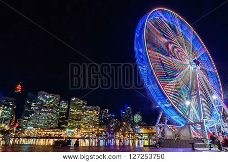 Sydney Australia - November 10 2015: Darling Harbour Ferris wheel at night time. Long exposure camera settings applied.