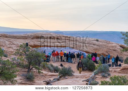 UTAH USA - APRIL 25 2014: people are waiting for a sunrise at Mesa Arch in Canyonlands National Park