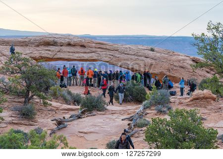 UTAH USA - APRIL 25 2014: people are waiting for a sunrise at Mesa Arch in Canyonlands National Park