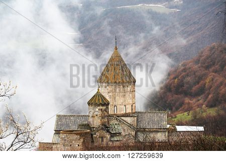 Ancient monastery Tatev covered with clouds in the mountains of Armenia. Was founded in year 906. 