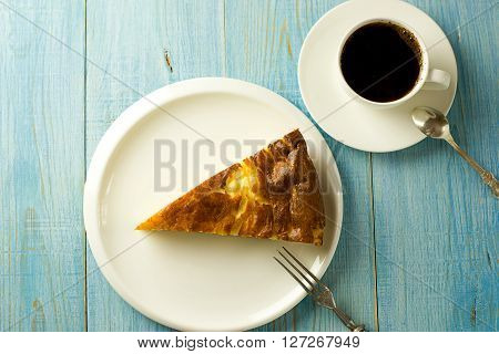 Piece of cake on a white plate on over blue
** Note: Shallow depth of field