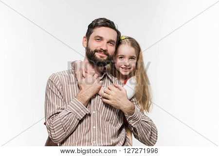 Girl hugging her father over a white background
