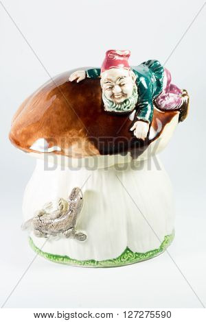Porcelain Gnome And Lizard On Mushroom On White Background