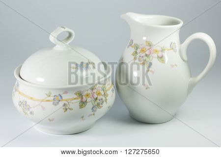 Sugar Bowl And Milk Jug With Flowers On White Background