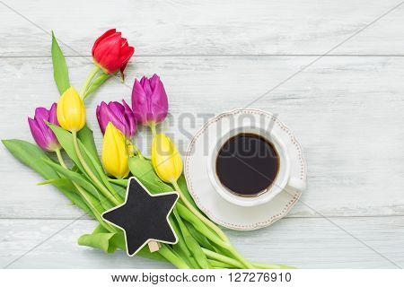 Colorful tulips with star shaped clip and coffee