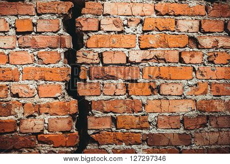 A brick wall with a crack red brick. A brick wall with a crack red brick