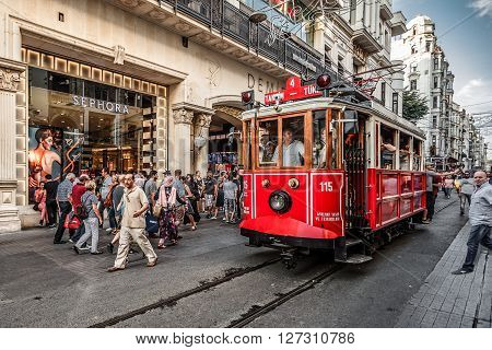 ISTANBUL TURKEY - AUGUST 8 2015: Tram going via one of the most famous avenues in Istanbul - ?stiklal Caddesi (Istiklal Street or Independence Avenue)