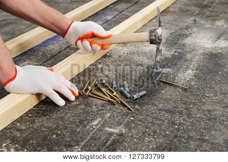 Worker put a plastic dubel in the concrete floor.