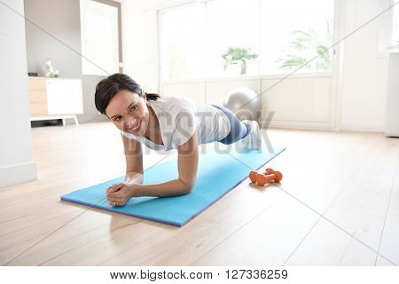 Woman doing workout exercises at home