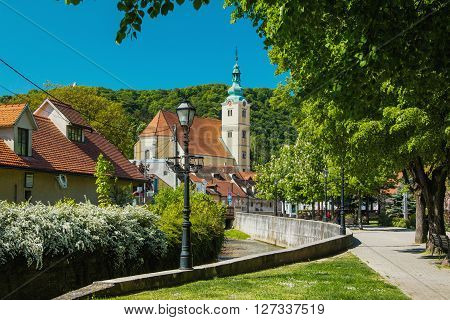 Samobor, Croatia - April 26nd, 2016: Catholic church and river in the center of Samobor, town in northern Croatia