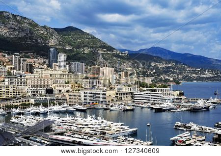 LA CONDAMINE, MONACO - MAY 16: Aerial view of the Port Hercules on May 16, 2015 in La Condamine, Monaco, during the preparations for the 73 Monaco Grand Prix, and Monte Carlo in the background