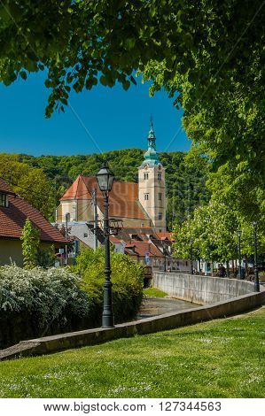 Samobor, Croatia - April 26nd, 2016: Catholic church and river in the center of Samobor, town in northern Croatia