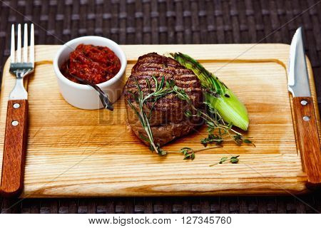Beautiful Juicy Well Done Steak With Sauce On A Wooden Board