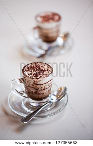 Italian traditional coffee macciato, made in Milan. This beverage contains dark chocolate, hot frothed milk and espresso.