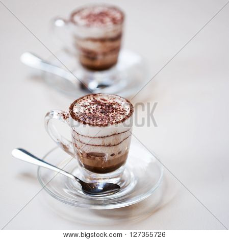 Italian traditional coffee macciato, made in Milan. This beverage contains dark chocolate, hot frothed milk and espresso.