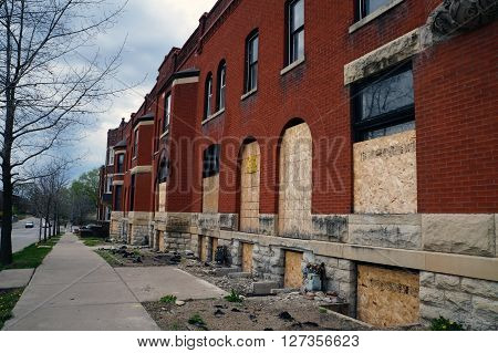JOLIET, ILLINOIS / UNITED STATES - APRIL 19, 2015: The historic Swinbank Terrace, built in 1890 as Romanesque-style row housing, sits abandoned on Hickory Street in Joliet.