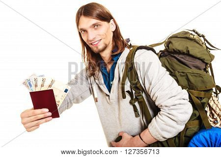 Man tourist backpacker holding passport full of money. Young guy hiker backpacking. Summer vacation travel. Studio shot. Isolated on white background.