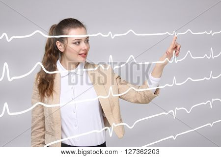 Doctor woman working with cardiogram lines