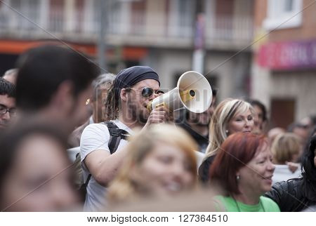 Badajoz Spain - March 29 2012: young demostrator with megaphone protesting against austerity cuts March against the Labor Reform approved by the Government of Spain on March 2012