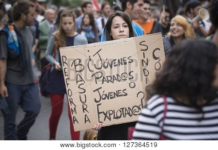 Badajoz Spain - March 29 2012: young girl demostrator with cardboard banner protesting against austerity cuts at demostration. March against the Labor Reform approved by the Government of Spain on March 2012
** Note: Soft Focus at 100%, best at smaller s