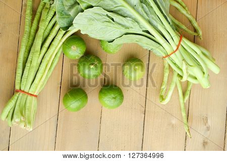 green lime yardlong bean and kale on wood floor