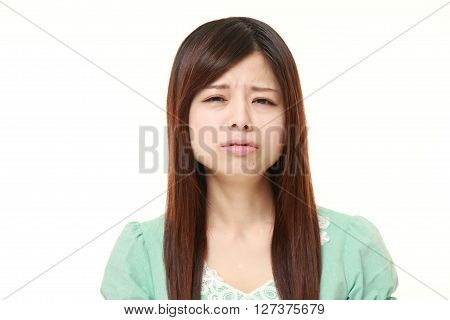 studio shot of perplexed woman on white background