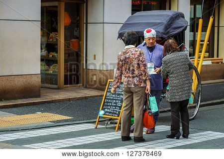 YOKOHAMA JAPAN - NOVEMBER 24 2015: Unidentified rickshaw driver on a street of Yokohama Chinatown