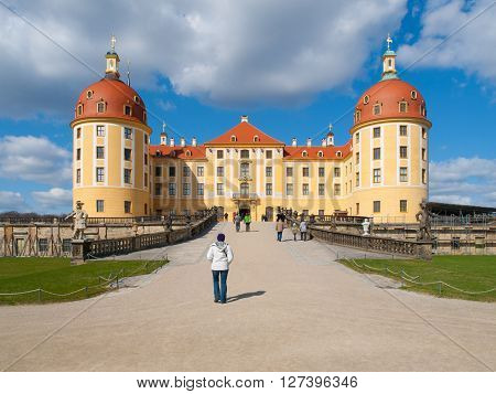 Baroque castle of Moritzburg with yellow facade and red roof on sunny day, Saxony, Germany