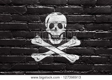The Traditional Jolly Roger Of Piracy Flag, Painted On Brick Wall