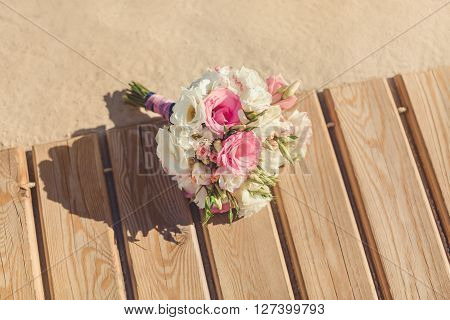 Bride's Pink and White Bouquet Laying on Pier. Wedding in Tropical Country Idea