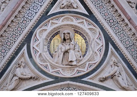FLORENCE, ITALY - JUNE 05: Our Lady of Sorrows supported by Angels bearing Flowers, Portal of Cattedrale di Santa Maria del Fiore, Florence, Italy on June 05, 2015