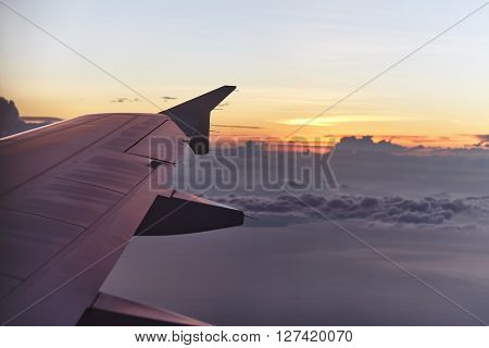flying aircraft wing on beautiful sunset. Travel concept
