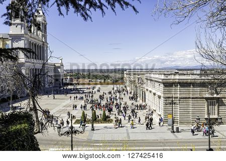 Madrid SPAIN - april 09 2016: visitors walking in Almudena square between Almudena Cathedral and entry to the royal palace on April 09 2016 in Madrid Spain