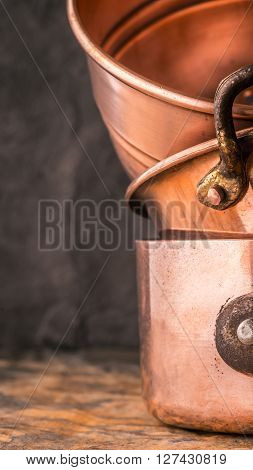 Copper pots and pans on the stone table